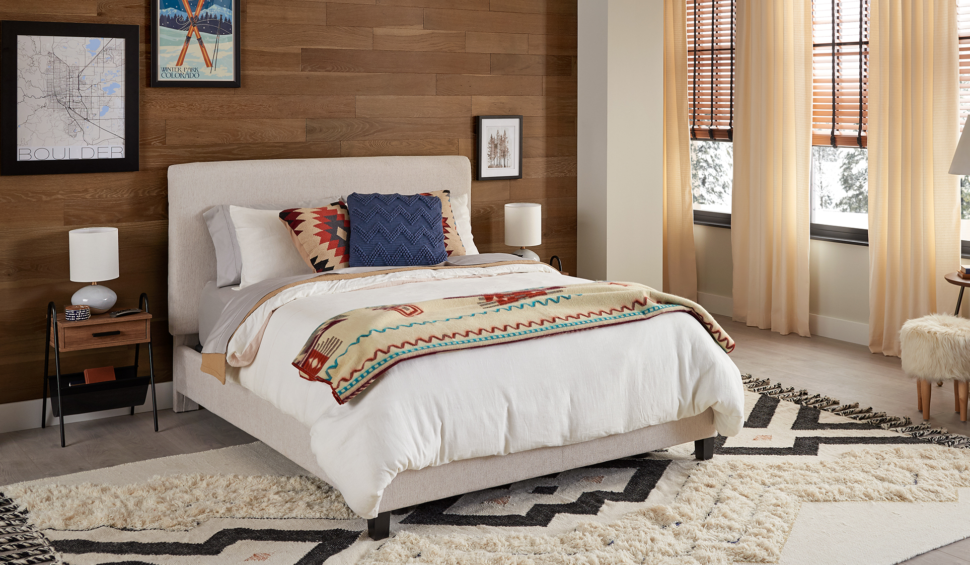 Mom and son eating breakfast in bed on a Sealy® bed