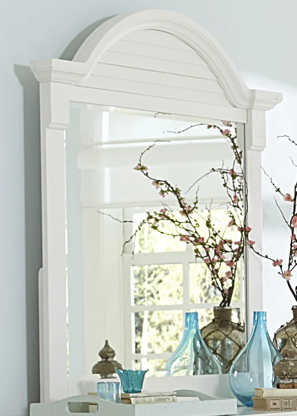 The Summer House Mirror by Liberty Furniture is made from oak and pine solids with an oyster white finish. This mirror features an arched crown molding frame.