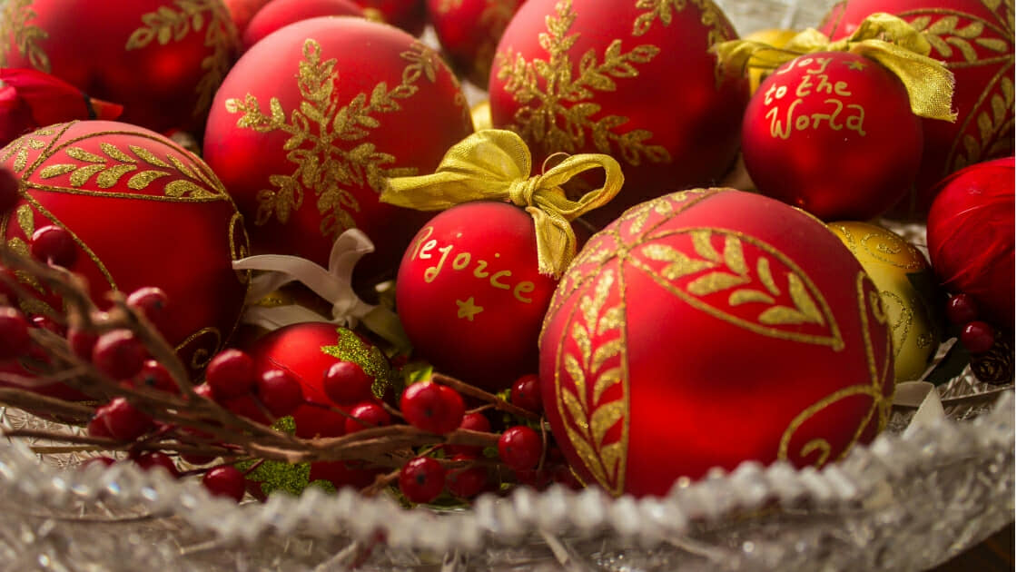 red and gold ornaments in a decorative bowl